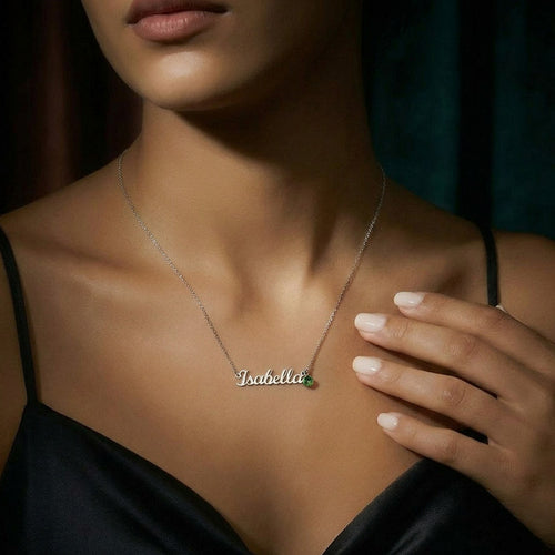 Woman wearing a personalized name necklace with birthstone charm